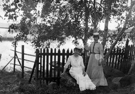 Two women wearing white student caps.